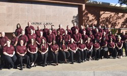 Image: Class #54 grouped in front of red brick building.